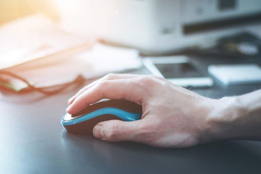 Close up of computer mouse used by a male hand