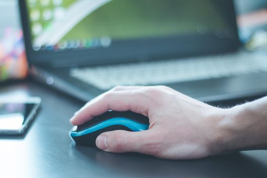 Close up of computer mouse used by a male hand