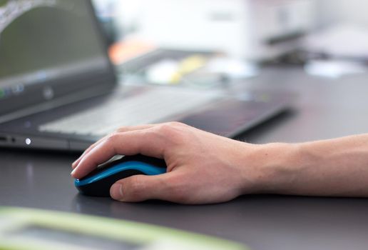 Close up of computer mouse used by a male hand