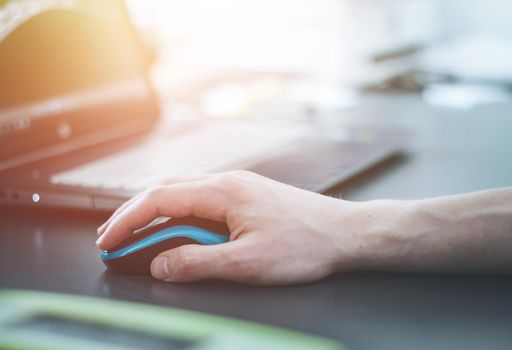 Close up of computer mouse used by a male hand