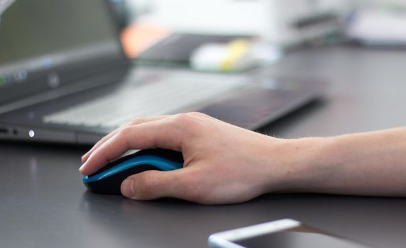 Close up of computer mouse used by a male hand