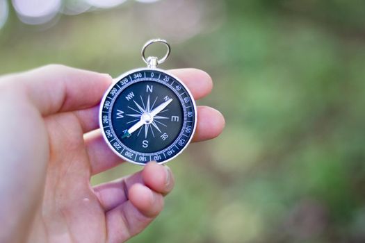 Vintage compass in man’s hand, adventure and discovery concept