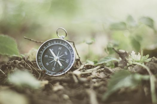 Vintage compass lying on the floor. Adventure and discovery concept.