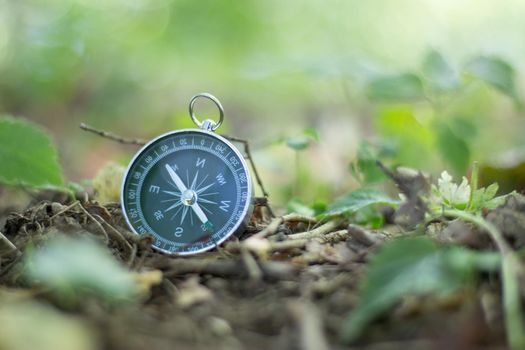Vintage compass lying on the floor. Adventure and discovery concept.