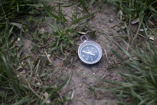 Vintage compass lying on the floor. Adventure and discovery concept.