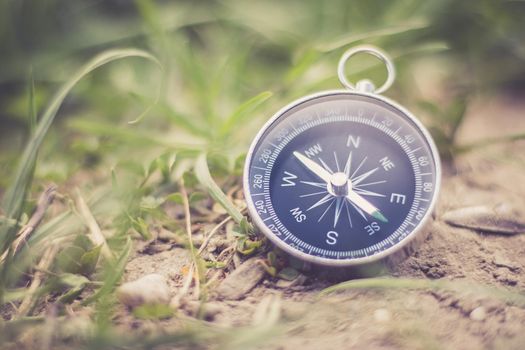 Vintage compass lying on the floor. Adventure and discovery concept.