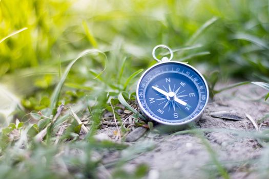 Vintage compass lying on the floor. Adventure and discovery concept.