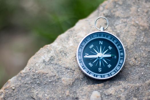 Vintage compass lying on the floor. Adventure and discovery concept.
