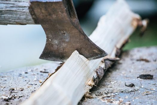 Sharpe axe is cutting wood for making fire, close up picture