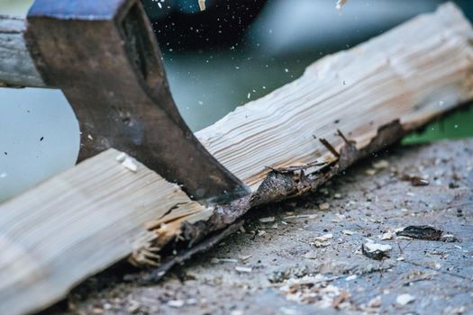 Sharpe axe is cutting wood for making fire, close up picture
