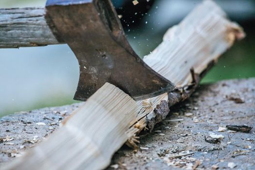 Sharpe axe is cutting wood for making fire, close up picture