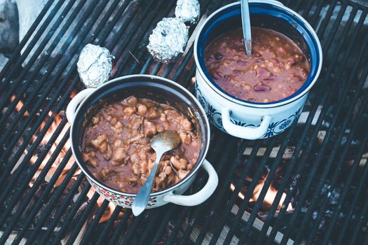 Tasty and spicy stew on bonfire, outdoors on a camping trip