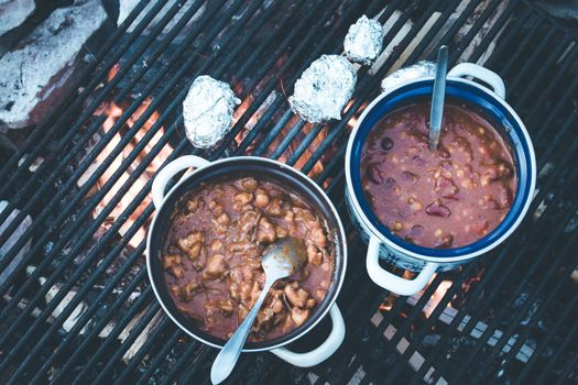 Tasty and spicy stew on bonfire, outdoors on a camping trip