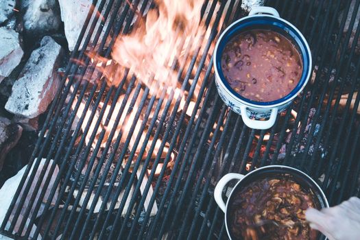 Tasty and spicy stew on bonfire, outdoors on a camping trip