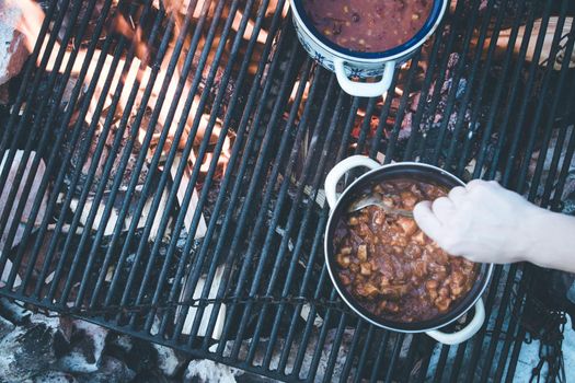 Tasty and spicy stew on bonfire, outdoors on a camping trip