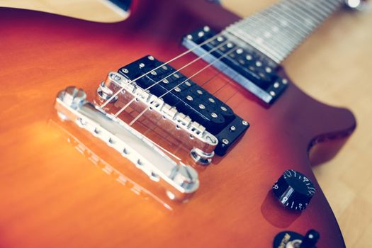 Electronic guitar in sunburst optic lying on the wooden floor