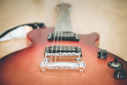 Electronic guitar in sunburst optic lying on the wooden floor