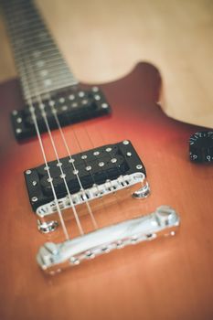 Electronic guitar in sunburst optic lying on the wooden floor