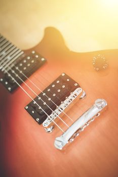 Electronic guitar in sunburst optic lying on the wooden floor