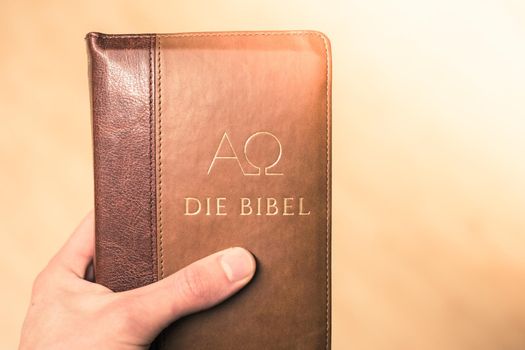 Young preacher is holding the holy bible, praying