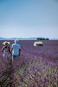 Provence, Lavender field France, Valensole Plateau, colorful field of Lavender Valensole Plateau, Provence, Southern France. Lavender field. Europe. Couple men and woman on vacation at the provence lavender fields,