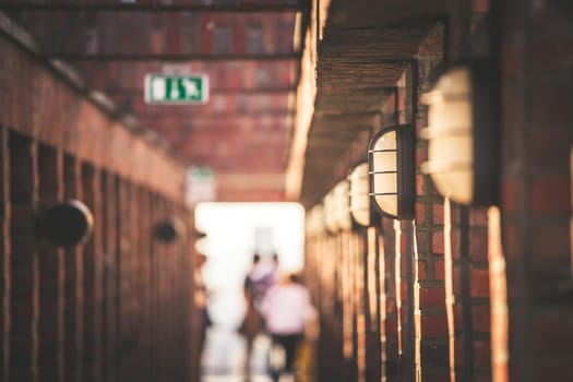 Lamps on a masoned building, blurry background with people