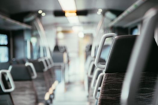 Interior of a public transport train, blurry background
