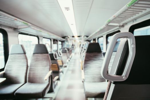 Interior of a public transport train, blurry background