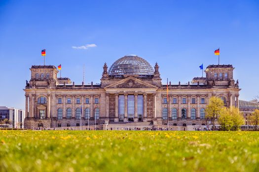 Picture of the Reichstag in Berlin in Springtime, green grass and flowers