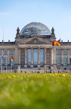 Picture of the Reichstag in Berlin in Springtime, green grass and flowers