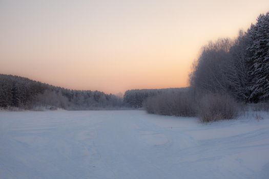  Winter and frosty nature. Frozen lake near the forest, all covered in snow.