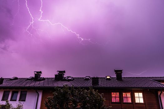 Lightning on the colored sky, roof of a building