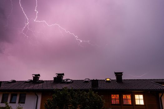 Lightning on the colored sky, roof of a building