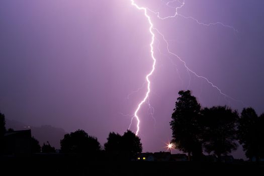 Lightning on the colored sky, night