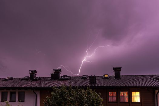 Lightning on the colored sky, roof of a building