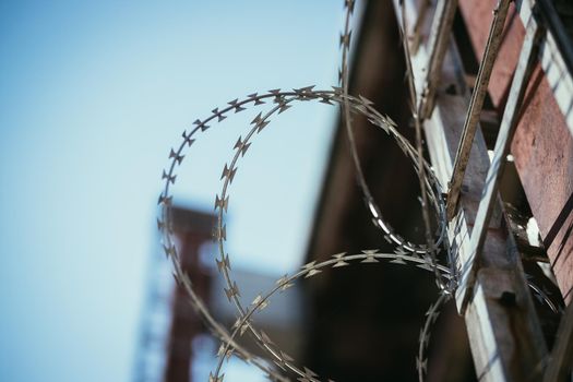 Close up perspective of barbed wire in the prison or on a military base