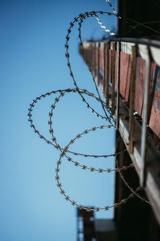 Close up perspective of barbed wire in the prison or on a military base