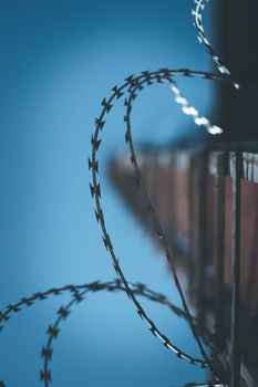 Close up perspective of barbed wire in the prison or on a military base