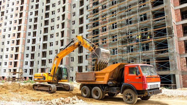 Excavator and cab over truck on the construction site