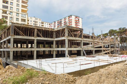 Building garage with scaffold at the construction site, exterior view