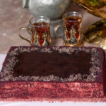 Arabic glass and red cake close up