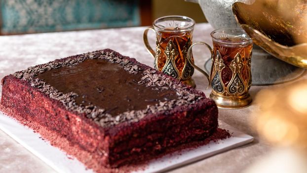 Arabic glass and red cake close up