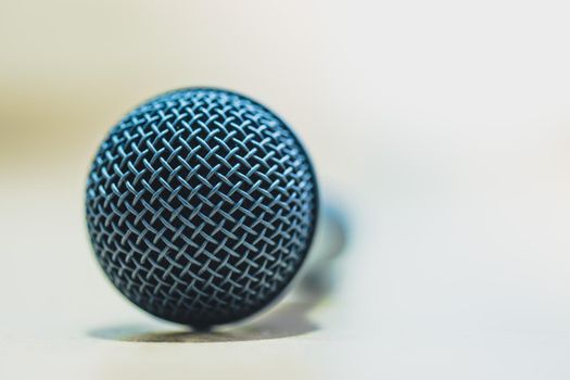 Black microphone stands on the desk. Interview, copy space.
