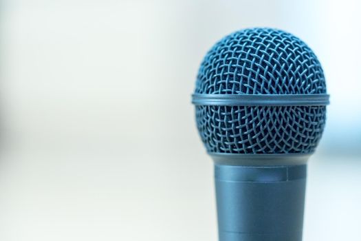 Black microphone stands on the desk. Interview, copy space.