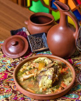 Beef meat soup with a wine bottle