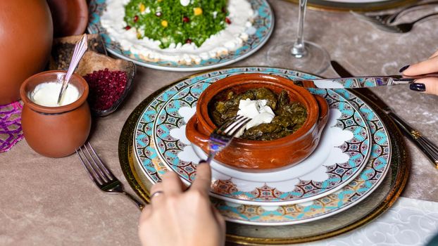 Woman eating Dolma, Azerbaijani meal top view