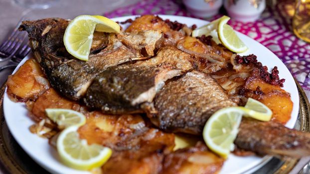 Grilled whole fish with a lemon close up