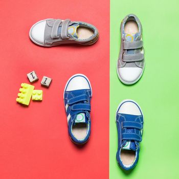 Child sport shoes on colorful background top view
