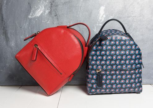 Red and blue woman backpacks isolated