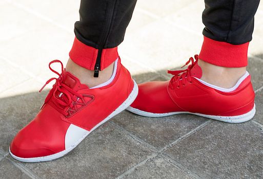 Woman with a red running shoes close up